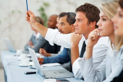 man raising hand in class