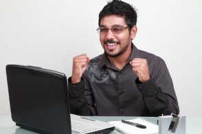 excited man playing computer learning game